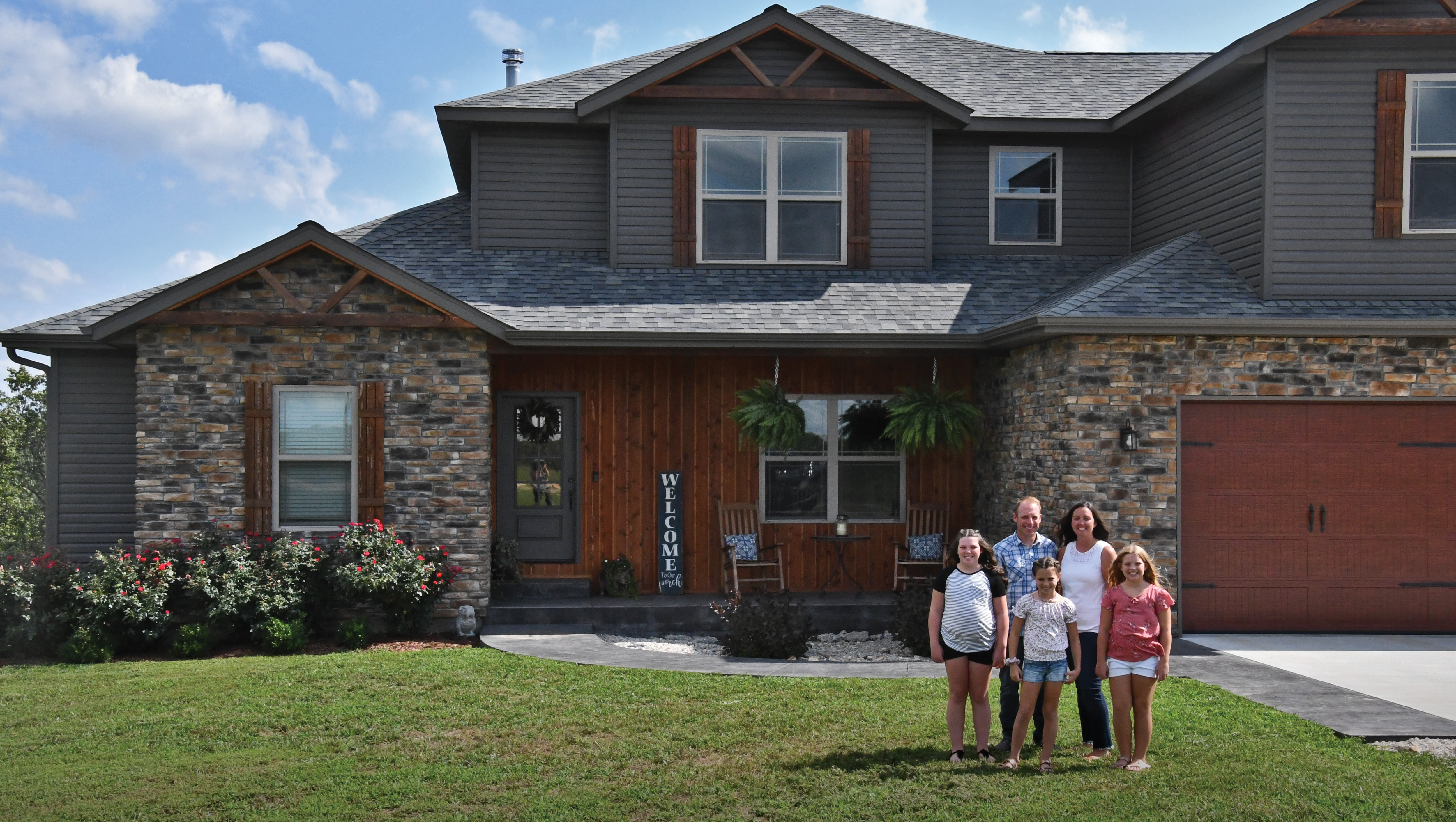 Family in front of House